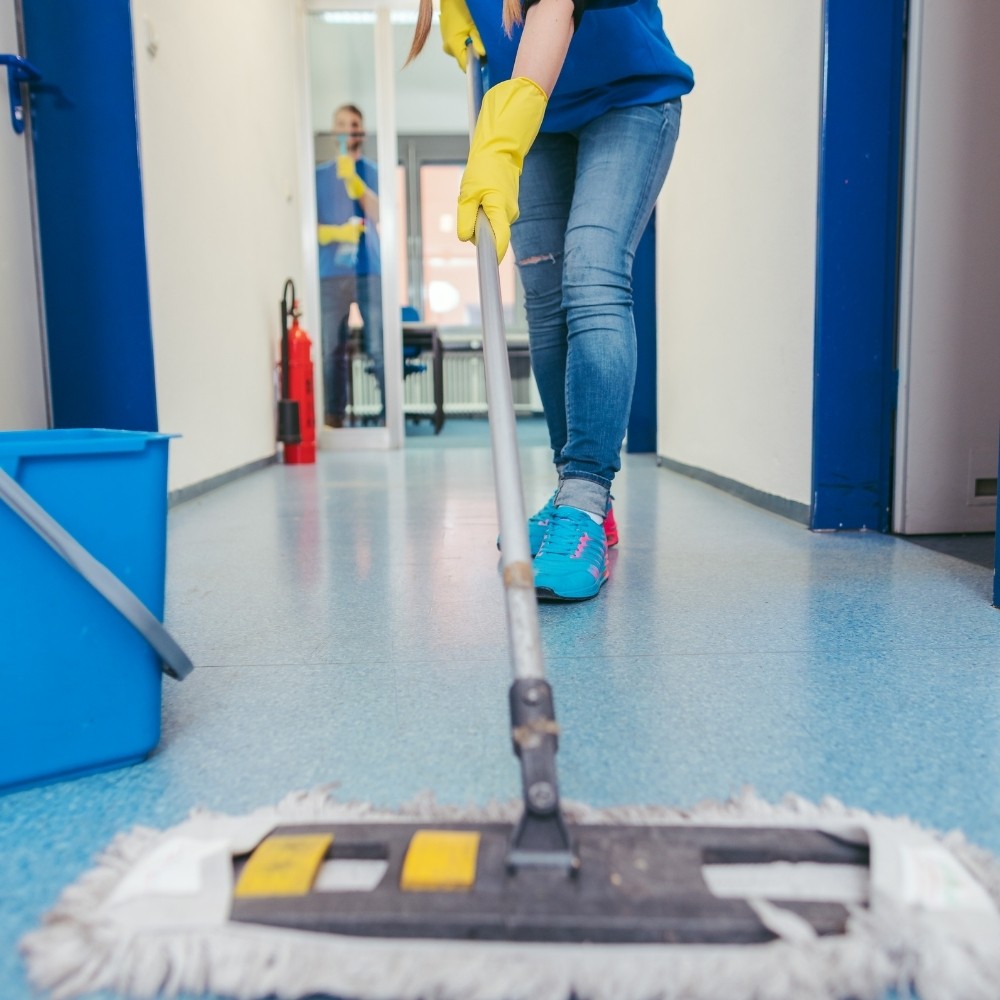 A picture of a person mopping the floor
